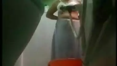 Desi MILF bares XXX charms taking a shower in front of a era